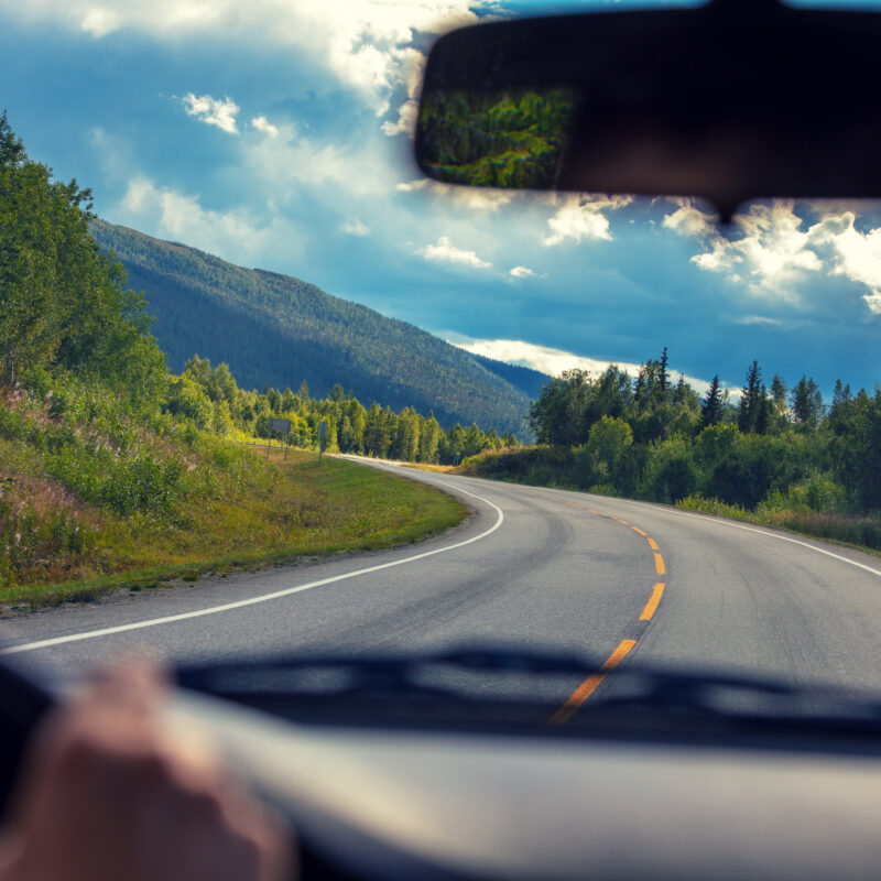 Driving a car on a mountain road. View from the windscreen of beautiful nature of Norway
