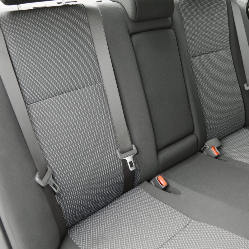 Close up image of clean backseat of car with fabric seats